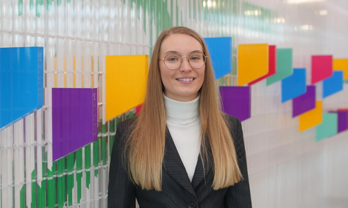 Lucy Johnson, director of Simplex Accounting, stands confidently at the entrance of the Associates of Accounting Technicians head office, ready to lead the way in the world of finance and accounting